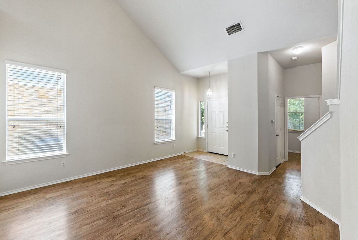 1114 Peyton Place Cedar Park, TX 78613 - Photo 8 of 39 a view of an empty room with wooden floor and a window