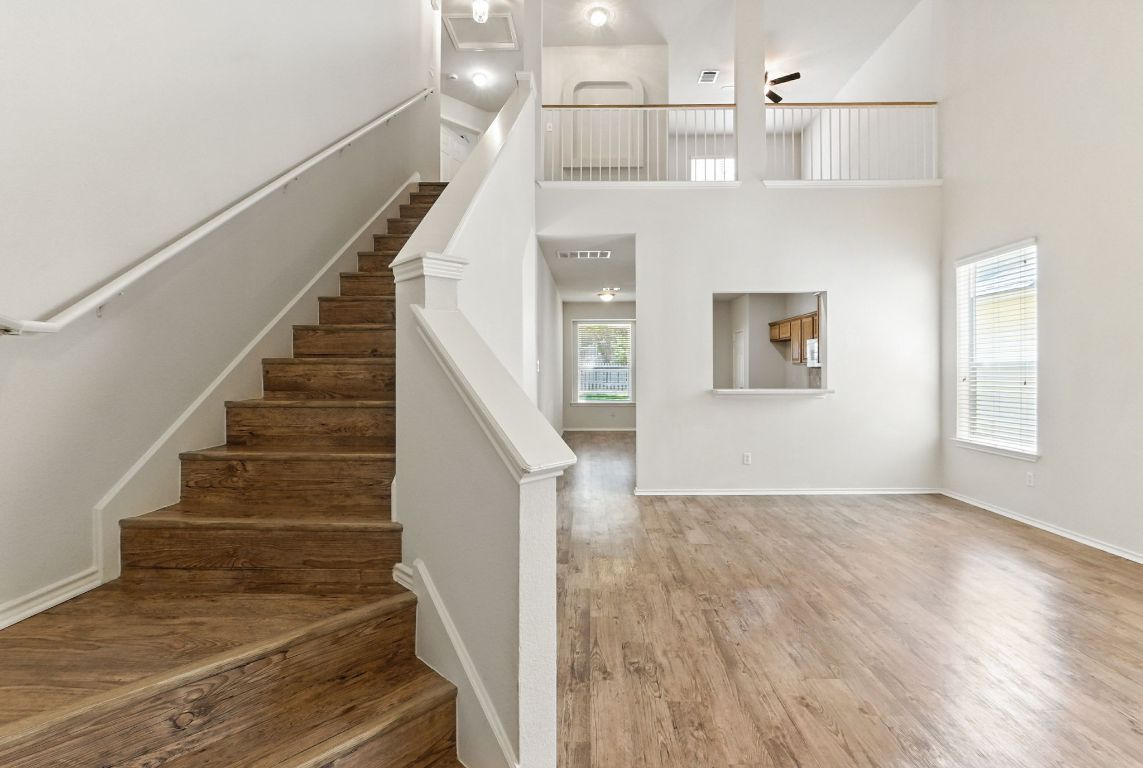 1114 Peyton Place Cedar Park, TX 78613 - Photo 9 of 39 Stairs featuring wood finished floors and a high ceiling