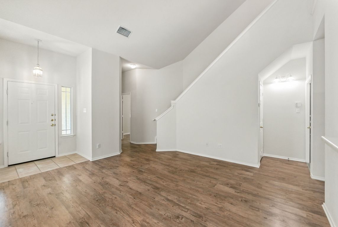 1114 Peyton Place Cedar Park, TX 78613 - Photo 10 of 39 a view of an empty room with wooden floor