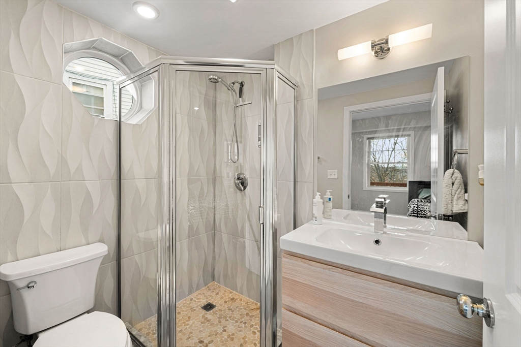 47 Sargent Street, Unit 3 Boston, MA 02125 - Photo 21 of 42 a bathroom with a sink a toilet and shower