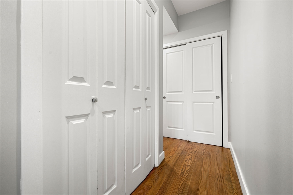 47 Sargent Street, Unit 3 Boston, MA 02125 - Photo 29 of 42 a view of a hallway with wooden floor