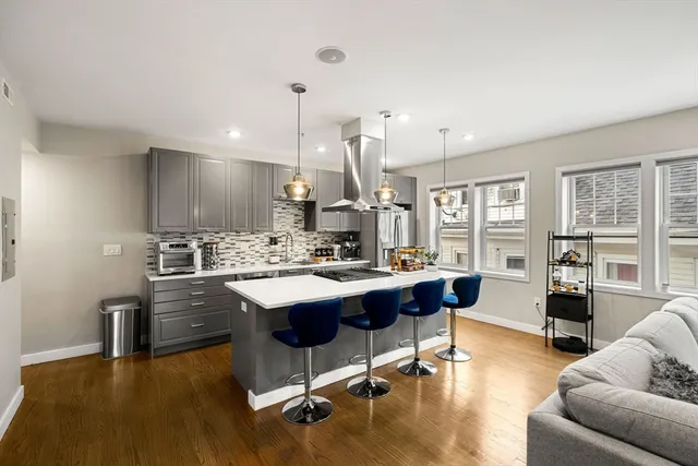 a kitchen with a stove sink and cabinets