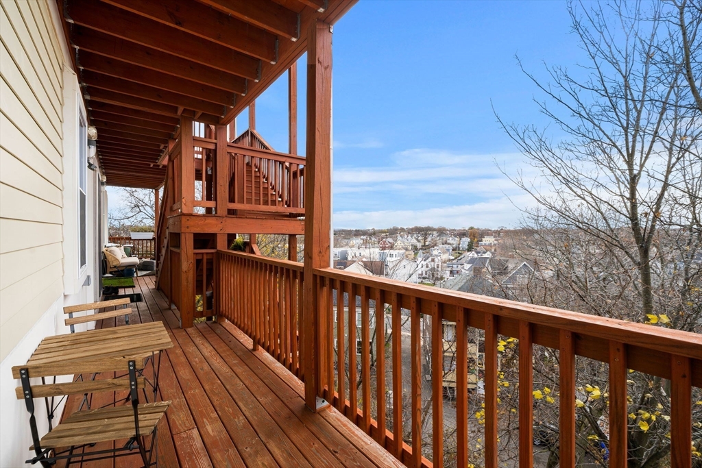47 Sargent Street, Unit 3 Boston, MA 02125 - Photo 33 of 42 a view of a balcony with wooden floor and fence