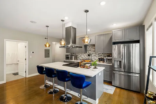 a bed sitting in a spacious bedroom next to a window