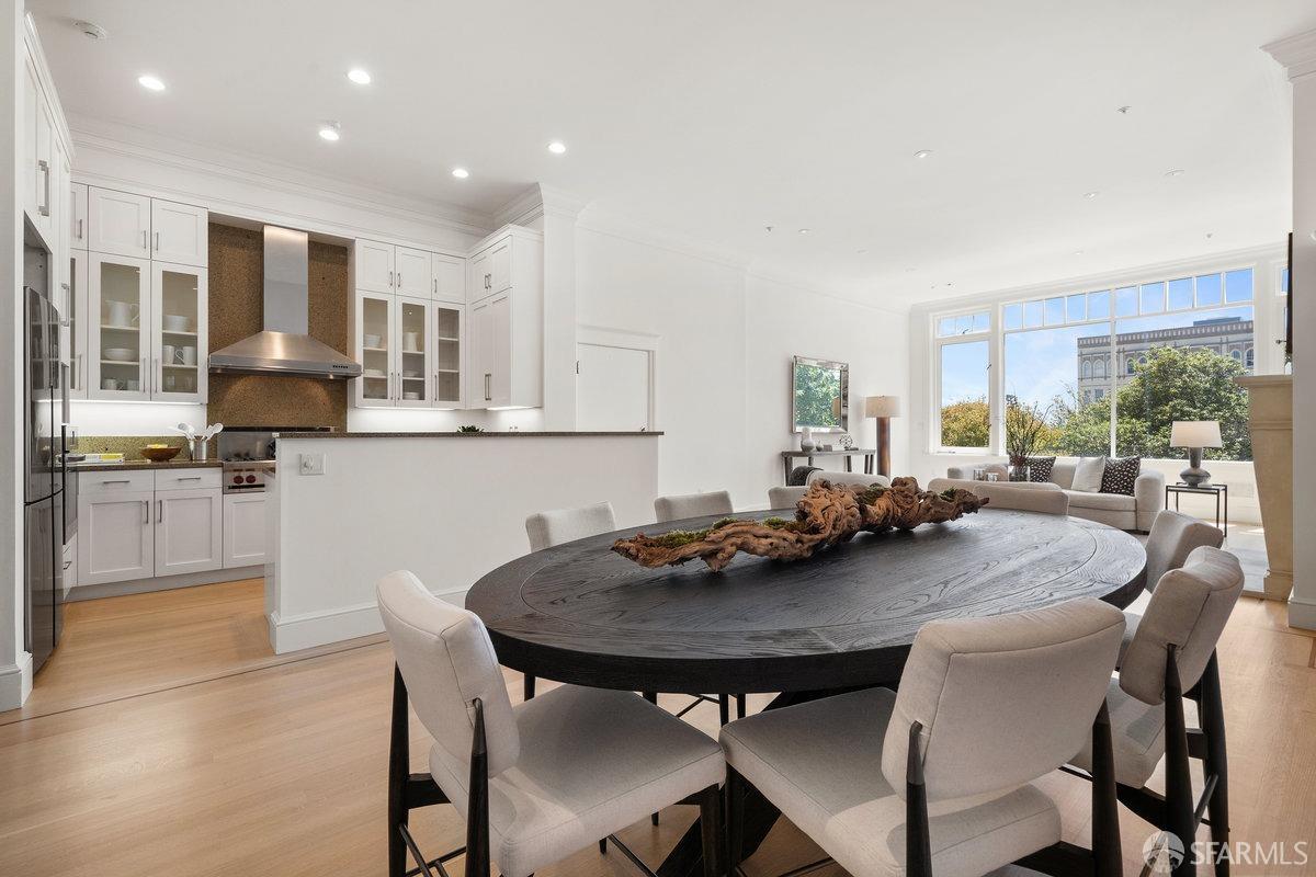2961 Pacific Avenue San Francisco, CA 94115 - Photo 14 of 64 a view of a dining room and kitchen with a table chairs and wooden floor