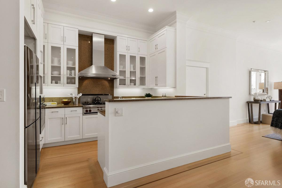 2961 Pacific Avenue San Francisco, CA 94115 - Photo 15 of 64 a kitchen with stainless steel appliances a refrigerator and a stove top oven