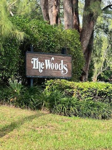 21911 Lake Forest Circle, Unit 201 Boca Raton, FL 33433 - Photo 2 of 8 a sign broad in front of flowers