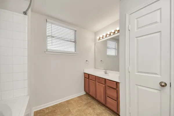 a spacious bathroom with a double vanity sink and a mirror