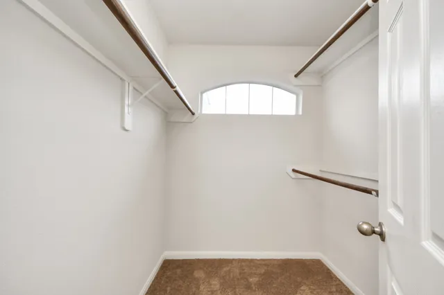 a spacious bathroom with a double vanity sink a mirror and a shower