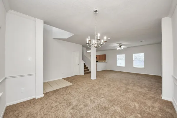 a view of a chandelier in big room and chandelier