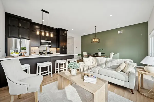 a living room with lots of furniture and kitchen view