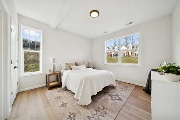 a spacious bedroom with a bed and a window