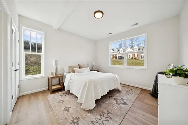 a spacious bedroom with a bed and a window
