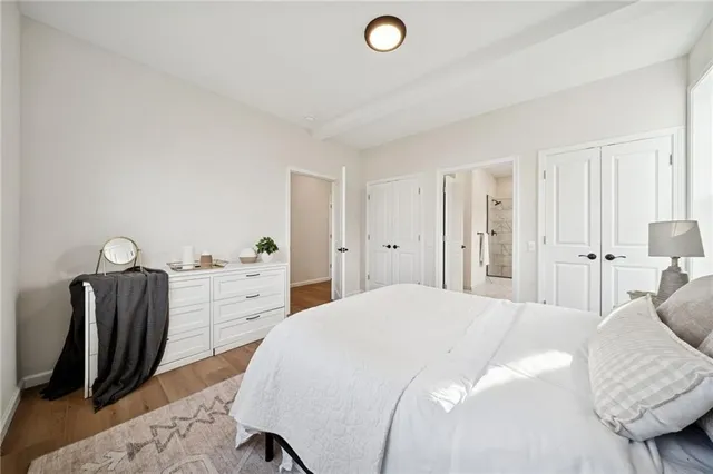 a spacious bedroom with a bed and furniture