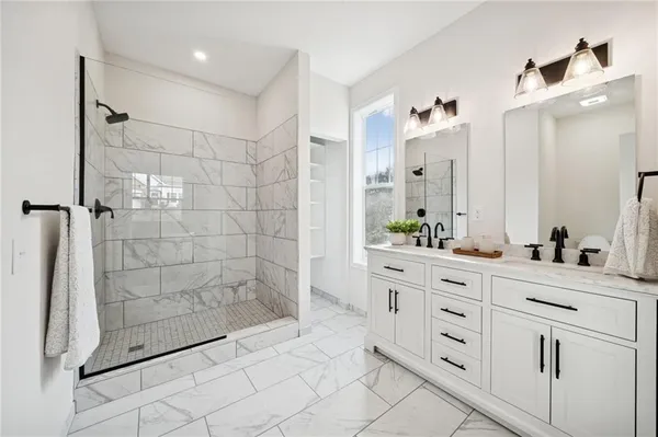 a bathroom with a double vanity sink and shower