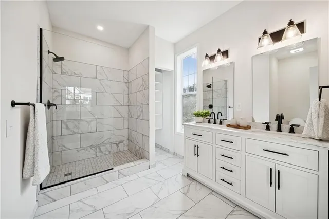 a bathroom with a double vanity sink and shower