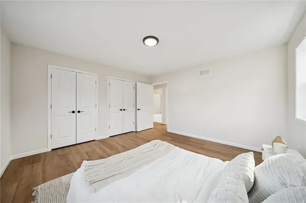 a bedroom with a bed and a night stand