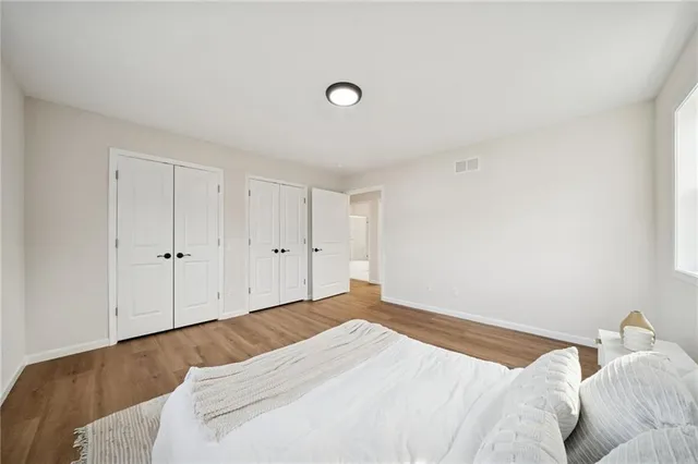 a bedroom with a bed and a night stand