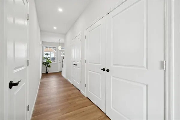 a view of a hallway with wooden floor