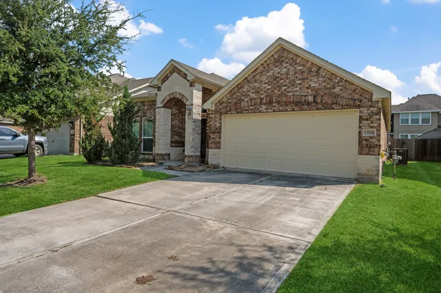 a front view of a house with a yard and garage