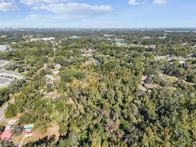 an aerial view of residential houses with city view
