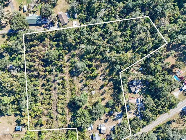 an aerial view of residential building with parking