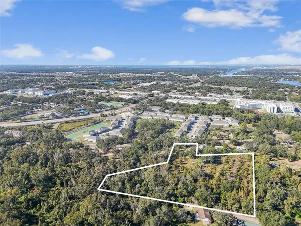 an aerial view of residential building with green space