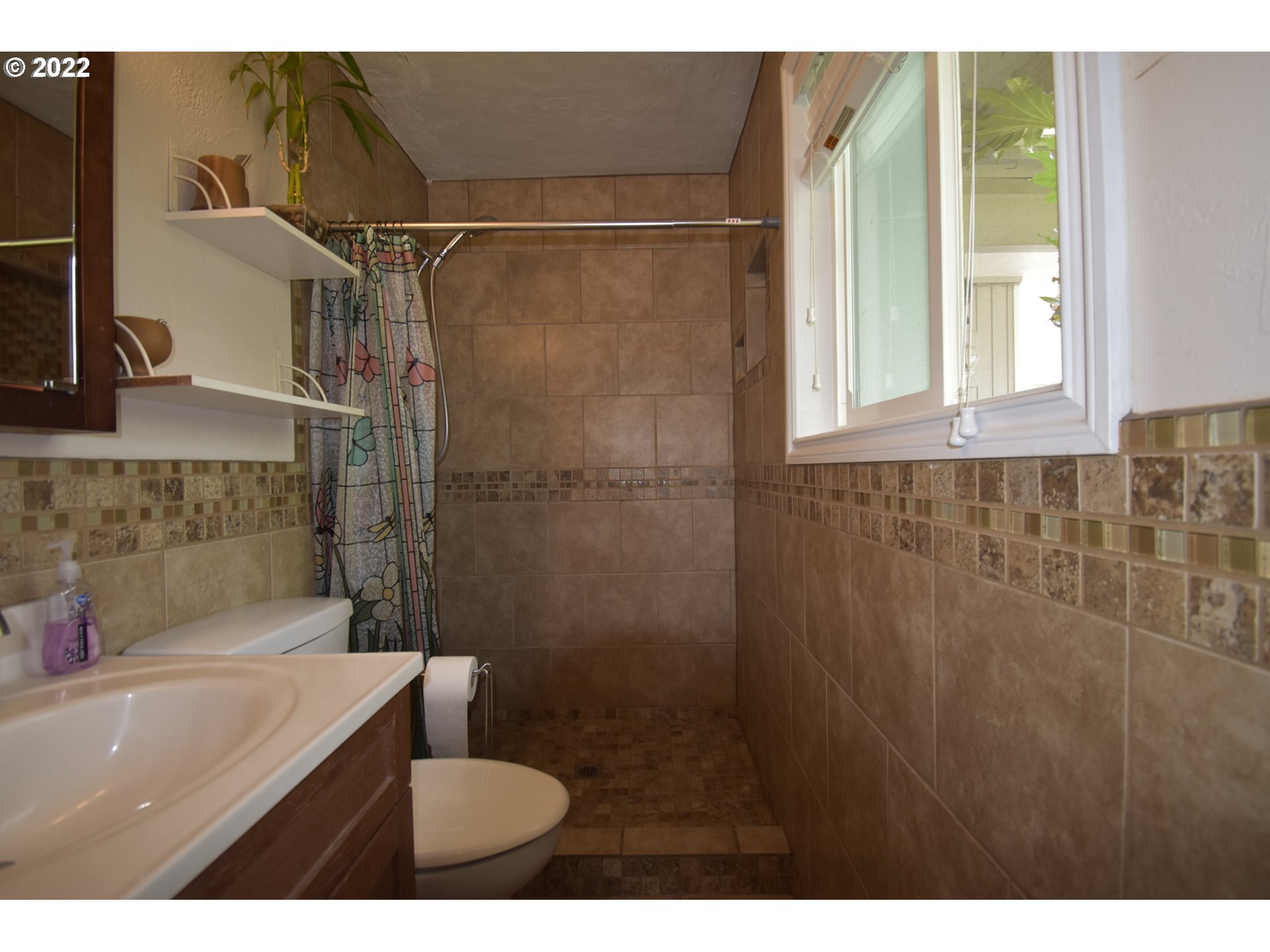 717 Night Hawk Lane Springfield, OR 97477 - Photo 11 of 32 a bathroom with a granite countertop sink toilet and shower