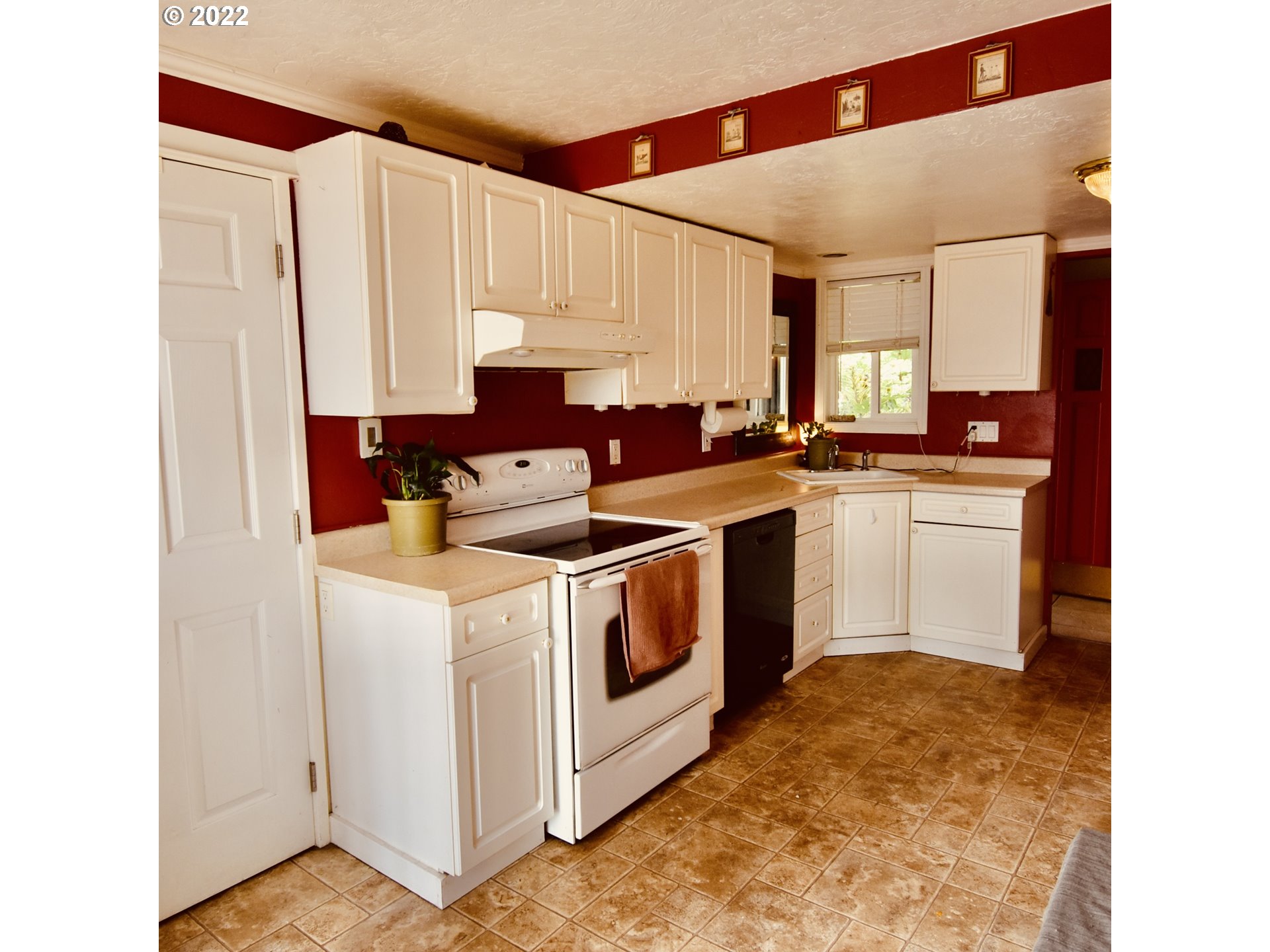 717 Night Hawk Lane Springfield, OR 97477 - Photo 3 of 32 a kitchen with a white cabinets and white appliances