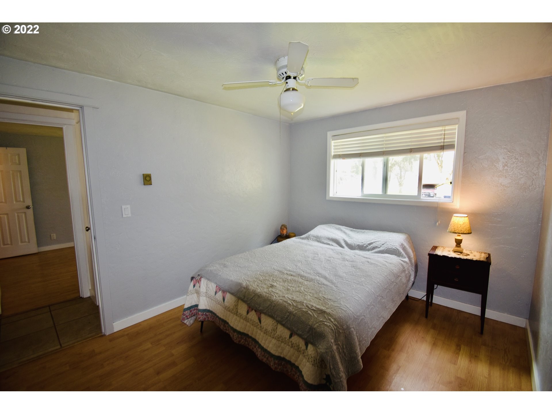 717 Night Hawk Lane Springfield, OR 97477 - Photo 8 of 32 a bedroom with a bed and a table in it