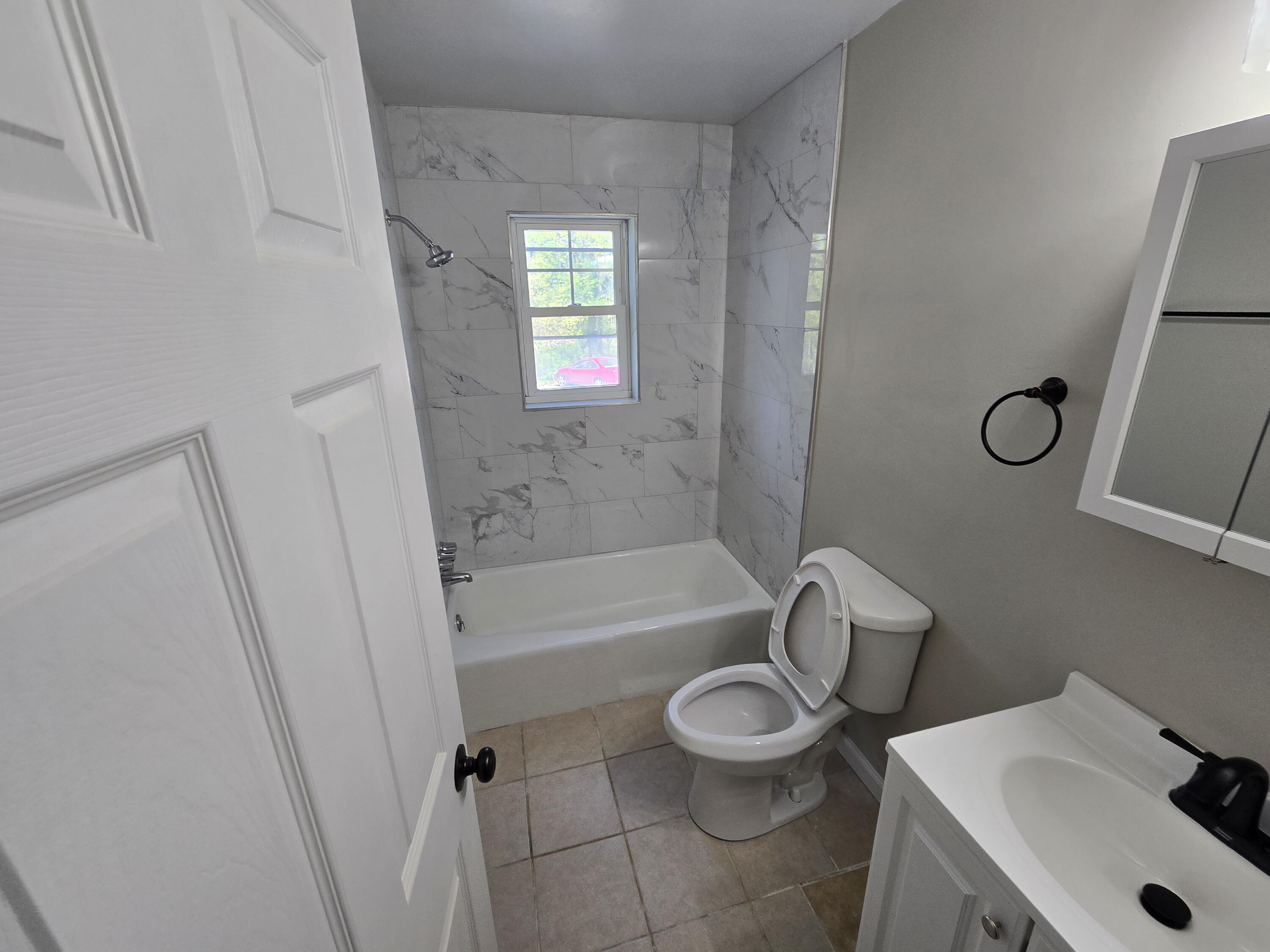 2657 Westover Avenue Southwest, Unit 9 Roanoke, VA 24015 - Photo 6 of 8 a bathroom with a sink mirror vanity and toilet