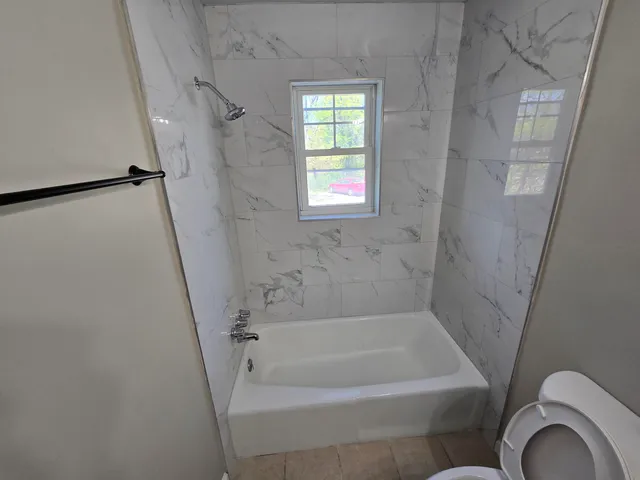 a bathroom with a bathtub and shower