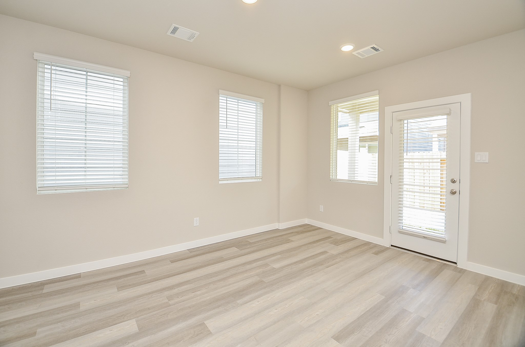 3107 Boulder Rnch Drive Houston, TX 77063 - Photo 15 of 40 a view of an empty room with wooden floor and a window