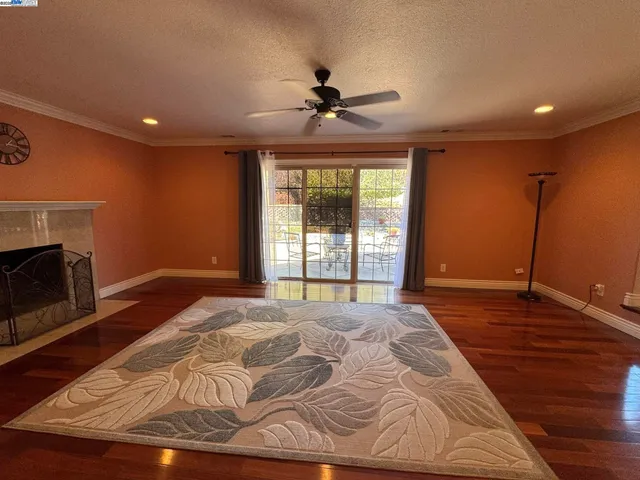 a view of empty room with wooden floor and fireplace