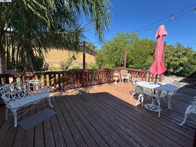 a view of a wooden chairs and table in patio