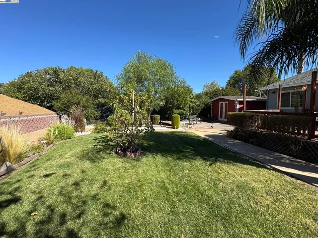 a front view of house with yard and trees around