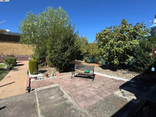 a view of a house with backyard and sitting area