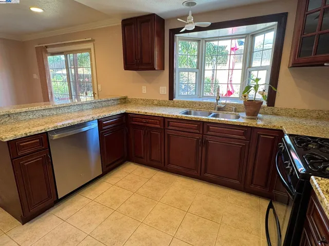 a kitchen with stainless steel appliances granite countertop a stove and a sink