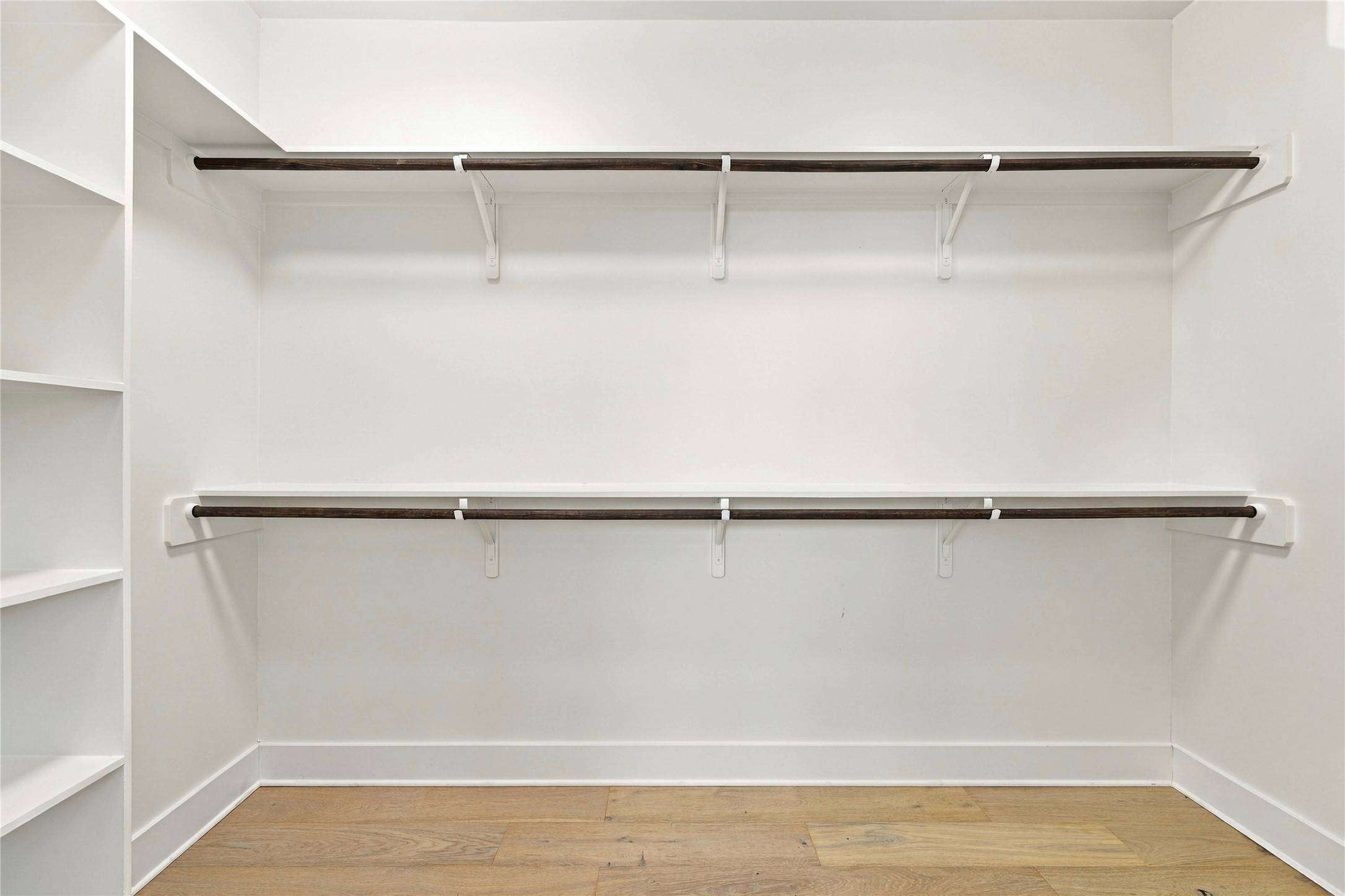 5006 Pecan Springs Road, Unit 7 Austin, TX 78723 - Photo 18 of 38 A spacious walk-in closet includes ample shelving and warm wood flooring.