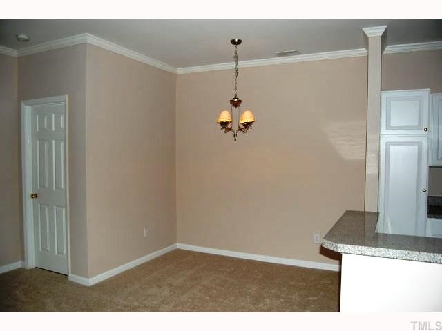 The dining room has crown and showcases an updated light fixture.