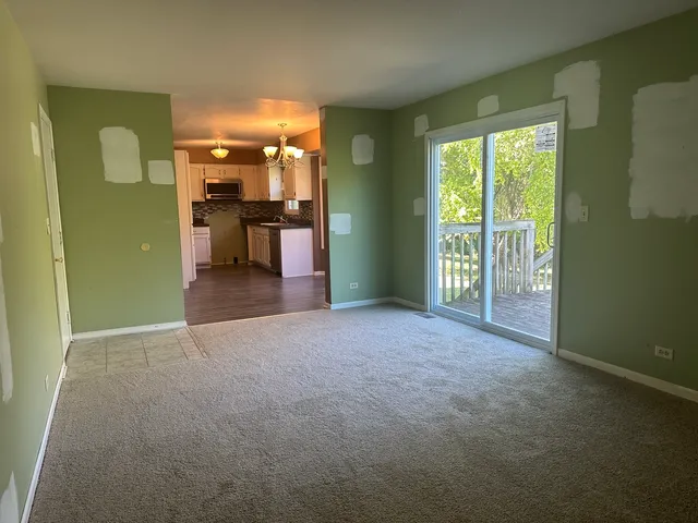 a view of a room with a kitchen