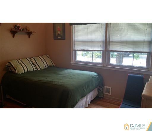 434 Plainfield Road Edison, NJ 08820 - Photo 12 of 16 a bed sitting in a bedroom next to a window