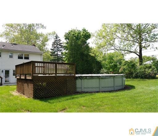 434 Plainfield Road Edison, NJ 08820 - Photo 14 of 16 a view of a backyard with a garden and trees