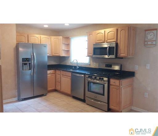434 Plainfield Road Edison, NJ 08820 - Photo 4 of 16 a kitchen with stainless steel appliances granite countertop a refrigerator a sink a stove and cabinets
