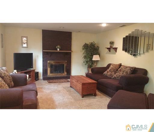 434 Plainfield Road Edison, NJ 08820 - Photo 10 of 16 a living room with furniture and a fireplace