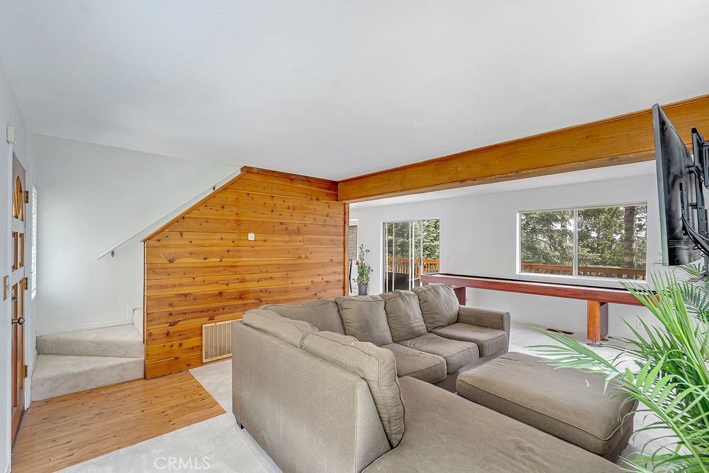 318 Old Toll Road Lake Arrowhead, CA 92352 - Photo 9 of 44 a living room with furniture a floor to ceiling window and potted plants