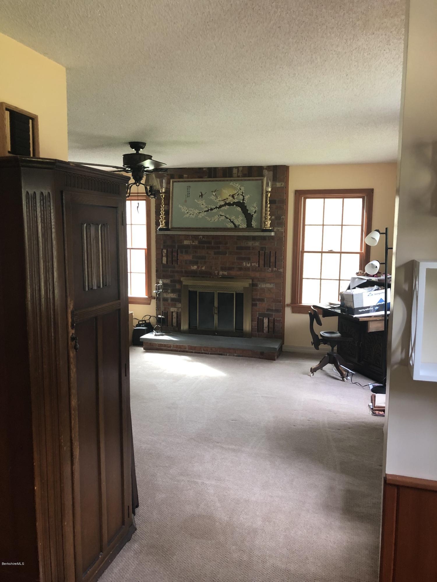 99 Middlefield Road Peru, MA 01235 - Photo 21 of 54 a living room with furniture and a fireplace