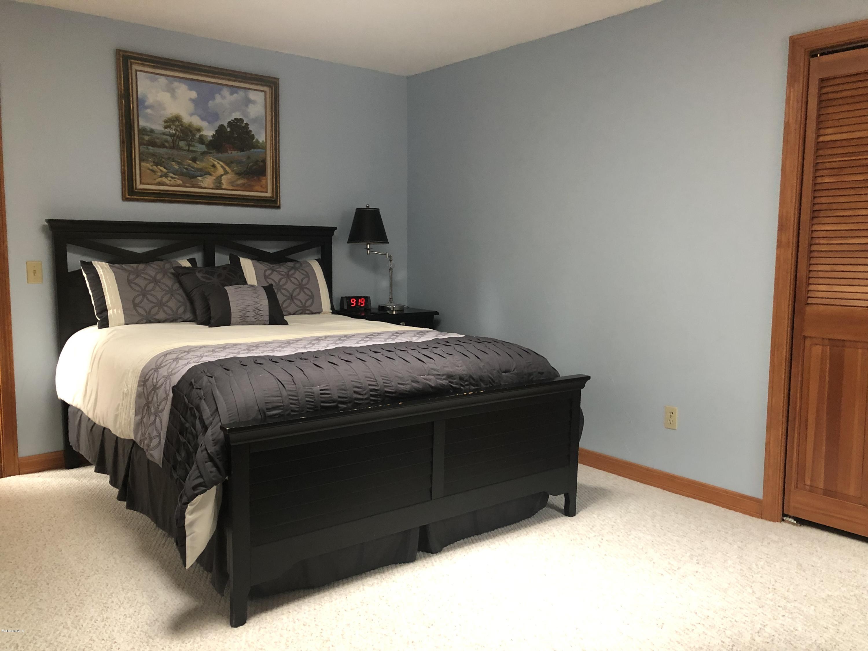 99 Middlefield Road Peru, MA 01235 - Photo 22 of 54 a bedroom with a bed and painting on the wall