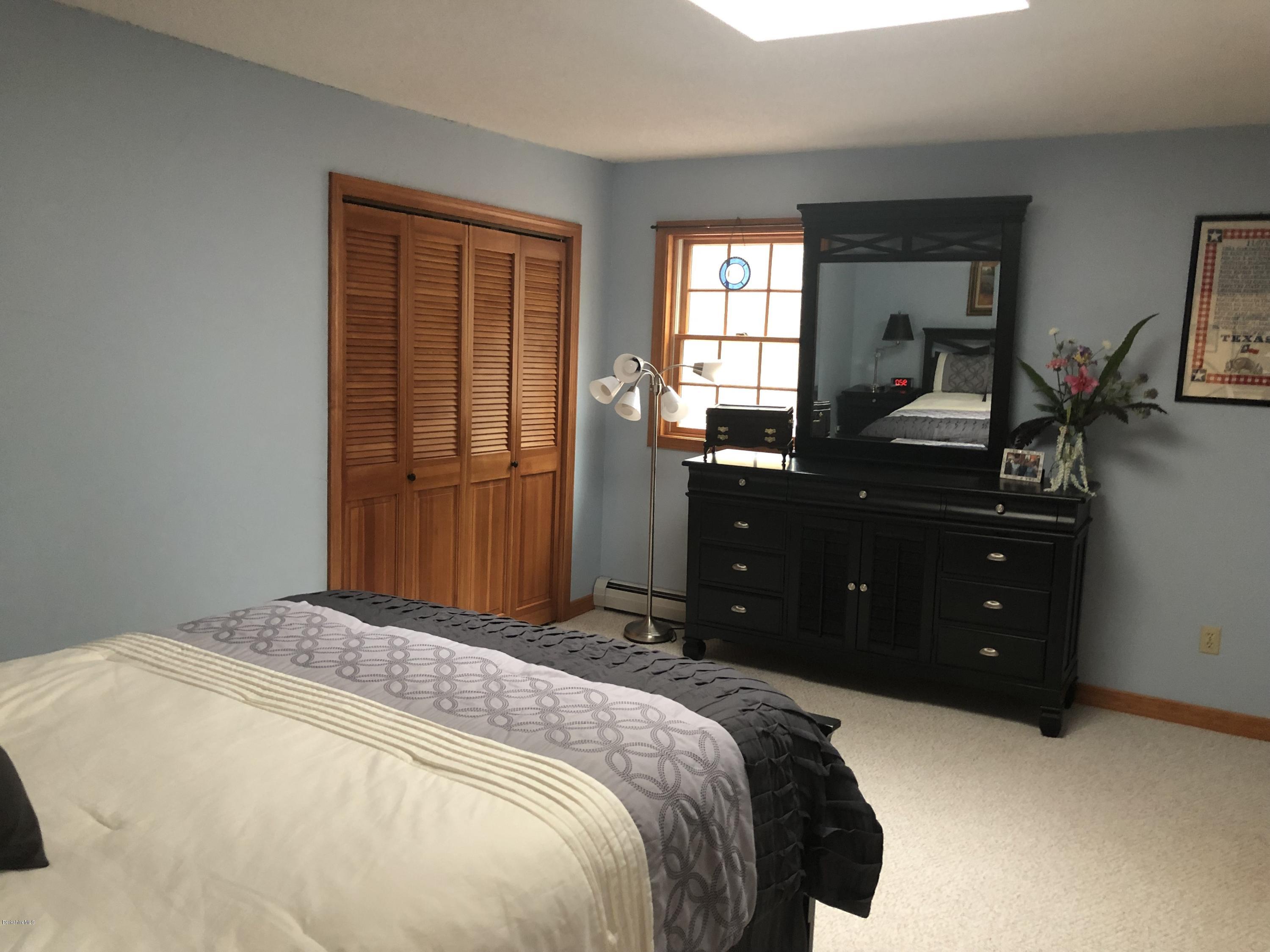 99 Middlefield Road Peru, MA 01235 - Photo 23 of 54 a bedroom with a bed and a closet