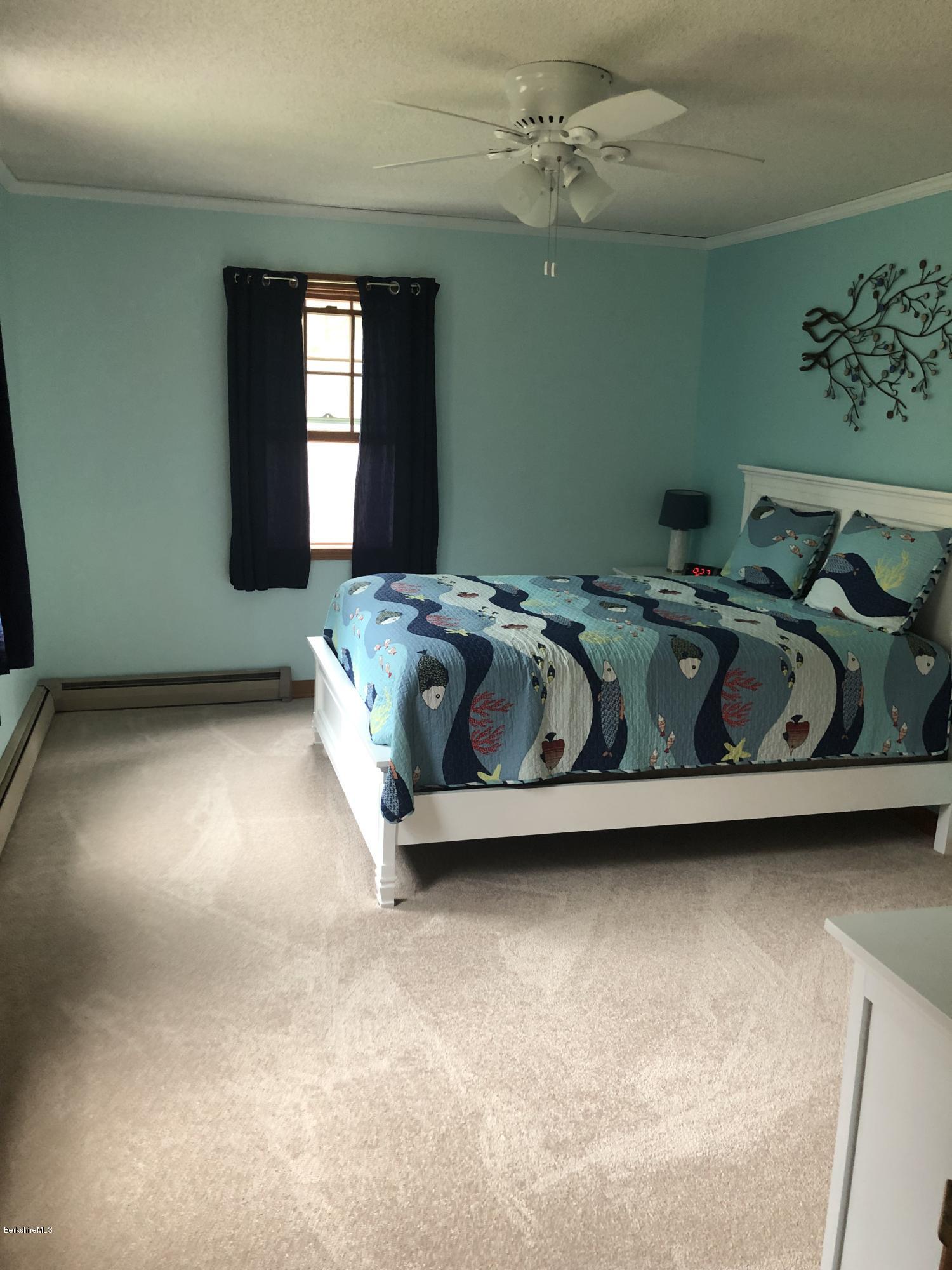 99 Middlefield Road Peru, MA 01235 - Photo 29 of 54 a bed sitting in a room next to a window